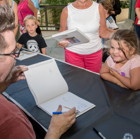 Drew Daywalt autographs a kid's event planner