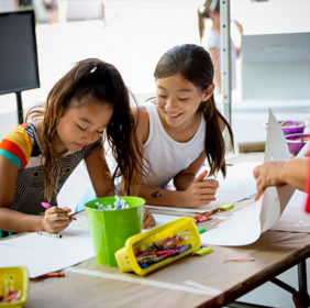 Two girls use crayons at Crayon Collection LACMA event